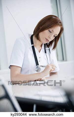 Picture - Female doctor working in an office. Fotosearch