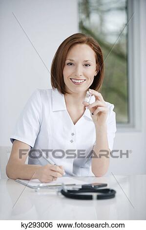 Female doctor working in an office View Large Photo Image Stock Photograph - Female doctor working in an office. Fotosearch
