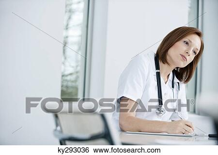 Female doctor working in an office View Large Photo Image Stock Photograph - Female doctor working in an office. Fotosearch