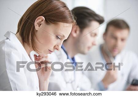 Female doctor working with her colleagues View Large Photo Image Stock Photograph - Female doctor working with her colleagues. Fotosearch