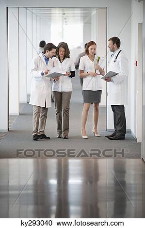 Stock Image - Four doctors discussing. Fotosearch