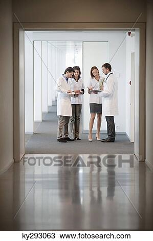 Four doctors examining medical reports View Large Photo Image Stock Image - Four doctors examining medical reports. Fotosearch