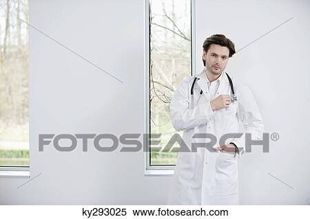Portrait of a doctor standing View Large Photo Image Stock Photography - Portrait of a doctor standing. Fotosearch