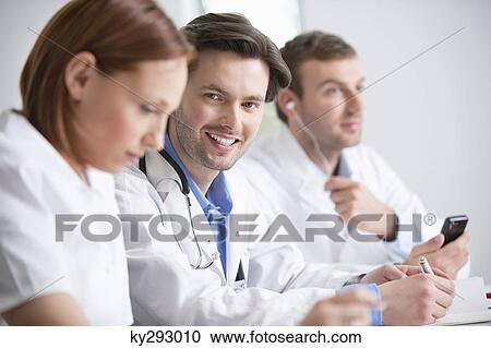 Portrait of a male doctor smiling View Large Photo Image Stock Image - Portrait of a male doctor smiling. Fotosearch