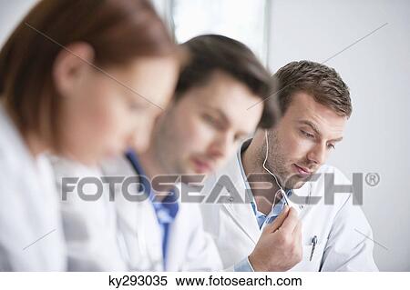 Three doctors working in an office View Large Photo Image Stock Photography - Three doctors working in an office. Fotosearch