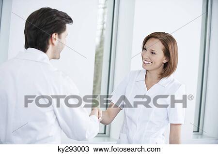 Two doctors shaking hands View Large Photo Image Stock Image - Two doctors shaking hands. Fotosearch