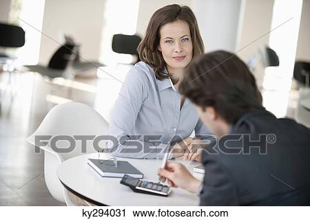Advisor using a calculator View Large Photo Image Stock Image - Advisor using a calculator. Fotosearch