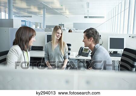 Business executives gossiping in an office View Large Photo Image Stock Image - Business executives gossiping in an office. Fotosearch