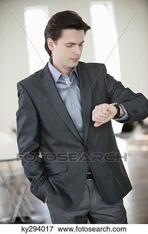 Stock Photo - Businessman checking the time. Fotosearch