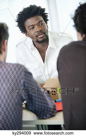 Businessmen discussing in an office View Large Photo Image Stock Photo - Businessmen discussing in an office. Fotosearch