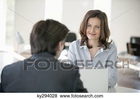 Businesswoman discussing with a businessman View Large Photo Image Stock Photo - Businesswoman discussing with a businessman. Fotosearch