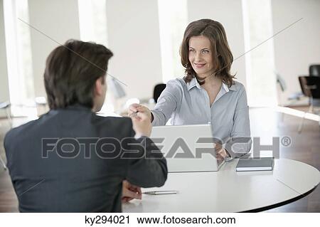 Businesswoman giving a credit card to a businessman View Large Photo Image Stock Image - Businesswoman giving a credit card to a businessman. Fotosearch