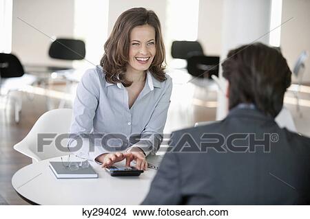 Businesswoman using a calculator View Large Photo Image Picture - Businesswoman using a calculator. Fotosearch