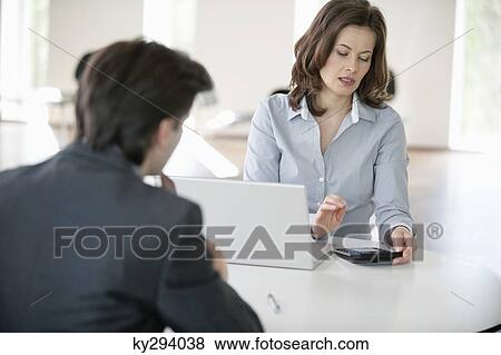 Businesswoman using a calculator View Large Photo Image Stock Photo - Businesswoman using a calculator. Fotosearch