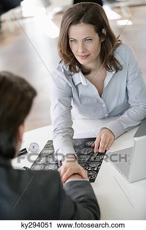 Doctor discussing with a patient View Large Photo Image Stock Image - Doctor discussing with a patient. Fotosearch