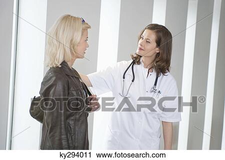 Female doctor consoling a patient View Large Photo Image Stock Image - Female doctor consoling a patient. Fotosearch