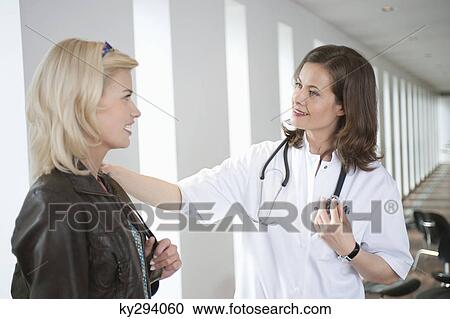 Stock Image - Female doctor consoling a patient. Fotosearch