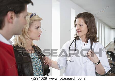Female doctor consoling a patient View Large Photo Image Stock Photo - Female doctor consoling a patient. Fotosearch