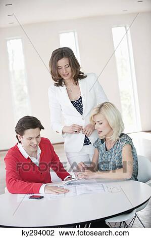 Financial advisor discussing with a couple View Large Photo Image Stock Image - Financial advisor discussing with a couple. Fotosearch