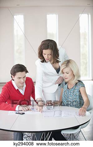 Financial advisor discussing with a couple View Large Photo Image Stock Photo - Financial advisor discussing with a couple. Fotosearch