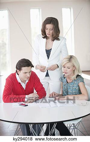 Financial advisor discussing with a couple View Large Photo Image Stock Photo - Financial advisor discussing with a couple. Fotosearch