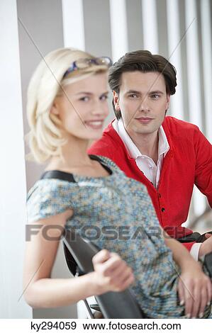 Portrait of a woman smiling with a man beside her View Large Photo Image Stock Photo - Portrait of a woman smiling with a man beside her. Fotosearch
