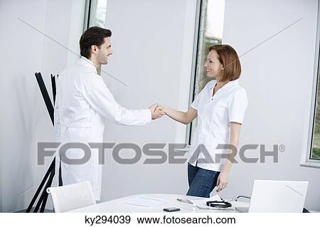 Two doctors shaking hands View Large Photo Image Stock Photo - Two doctors shaking hands. Fotosearch