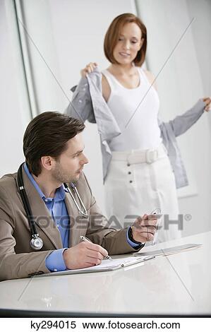 Woman getting dressed after treatment View Large Photo Image Stock Photography - Woman getting dressed after treatment. Fotosearch