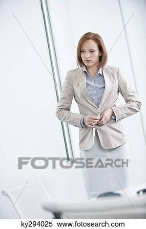 Woman getting dressed in an office View Large Photo Image Stock Photography - Woman getting dressed in an office. Fotosearch
