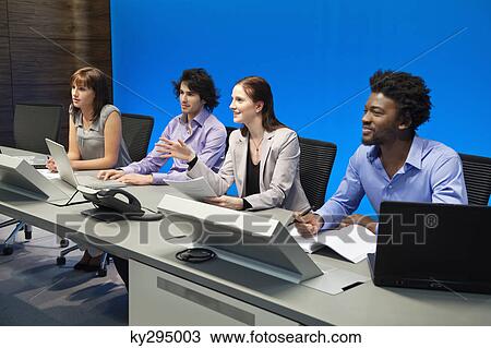 Stock Image - Business executives working in a control room. Fotosearch