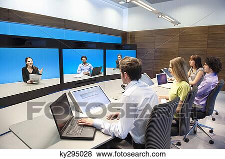 Business executives working in a control room View Large Photo Image Stock Photo - Business executives working in a control room. Fotosearch