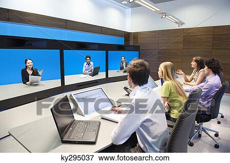 Stock Photo - Business executives working in a control room. Fotosearch