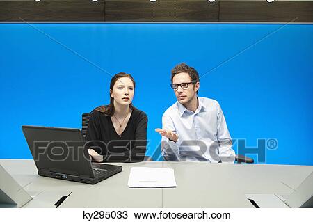 Business executives working on a laptop in a conference room View Large Photo Image Stock Image - Business executives working on a laptop in a conference room. Fotosearch