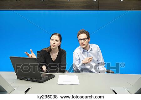 Business executives working on a laptop in a conference room View Large Photo Image Stock Photo - Business executives working on a laptop in a conference room. Fotosearch