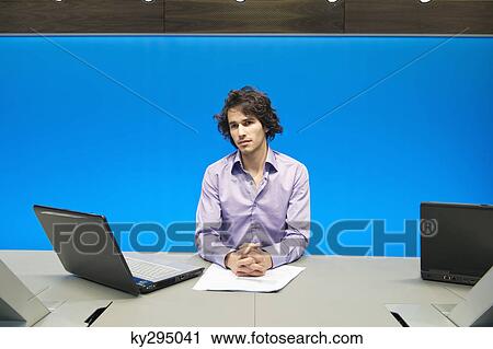 Stock Image - Businessman at a conference table with a laptop. Fotosearch