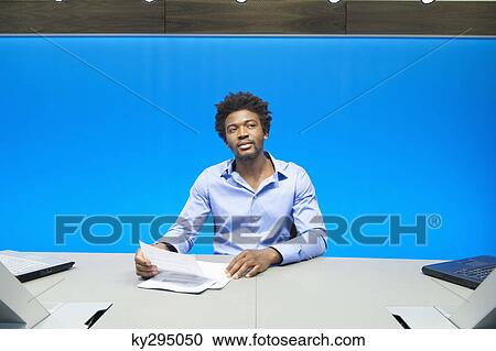 Businessman reading documents in a conference room View Large Photo Image Stock Image - Businessman reading documents in a conference room. Fotosearch