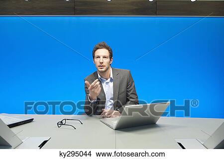 Businessman working on a laptop in a conference room View Large Photo Image Picture - Businessman working on a laptop in a conference room. Fotosearch