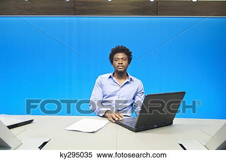 Businessman working on a laptop in a conference room View Large Photo Image Stock Photography - Businessman working on a laptop in a conference room. Fotosearch