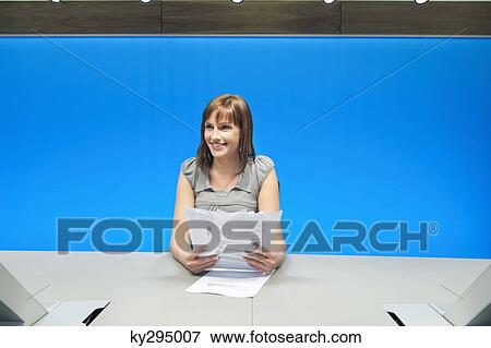 Businesswoman doing paperwork in a conference room View Large Photo Image Stock Photo - Businesswoman doing paperwork in a conference room. Fotosearch