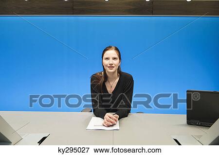 Stock Photo - Businesswoman doing paperwork in a conference room. Fotosearch