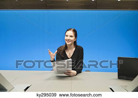 Businesswoman doing paperwork in a conference room View Large Photo Image Stock Photo - Businesswoman doing paperwork in a conference room. Fotosearch