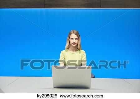 Businesswoman working on a laptop in a conference room View Large Photo Image Stock Photograph - Businesswoman working on a laptop in a conference room. Fotosearch