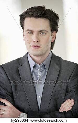 Businessman standing with his arms crossed View Large Photo Image Picture - Businessman standing with his arms crossed. Fotosearch