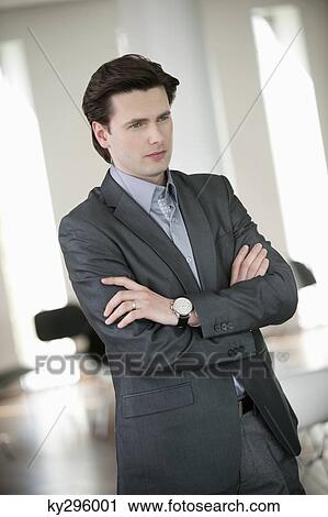 Businessman standing with his arms crossed View Large Photo Image Stock Image - Businessman standing with his arms crossed. Fotosearch