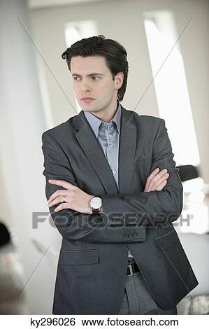 Businessman standing with his arms crossed View Large Photo Image Stock Photograph - Businessman standing with his arms crossed. Fotosearch