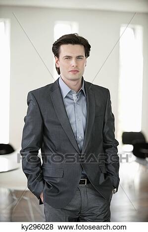 Businessman standing with his hands in his pocket View Large Photo Image Stock Photo - Businessman standing with his hands in his pocket. Fotosearch