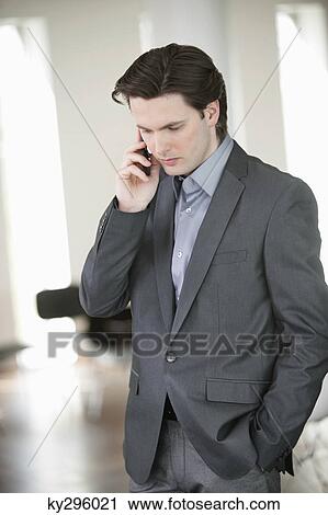Businessman talking on a mobile phone View Large Photo Image Stock Image - Businessman talking on a mobile phone. Fotosearch