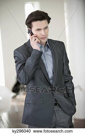 Businessman talking on a mobile phone View Large Photo Image Stock Image - Businessman talking on a mobile phone. Fotosearch