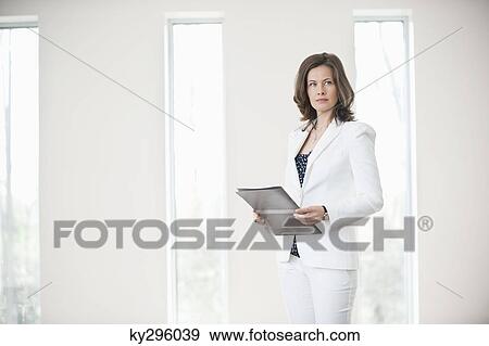 Businesswoman holding a file View Large Photo Image Stock Photo - Businesswoman holding a file. Fotosearch