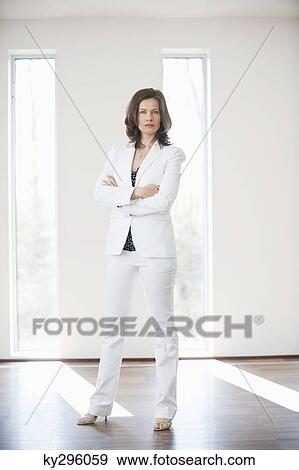 Businesswoman standing with her arms crossed View Large Photo Image Stock Photo - Businesswoman standing with her arms crossed. Fotosearch